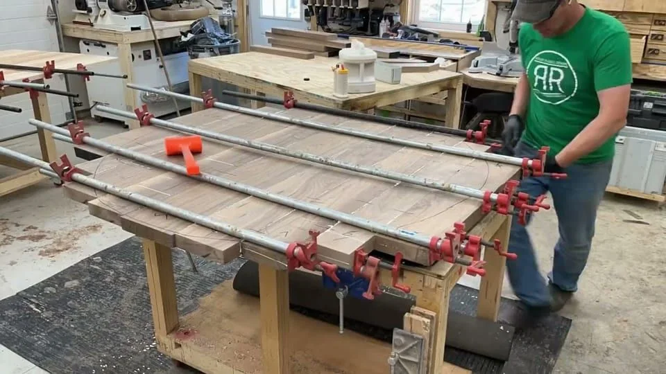 Still from the film “A solid walnut table on a bridle cross X base”.