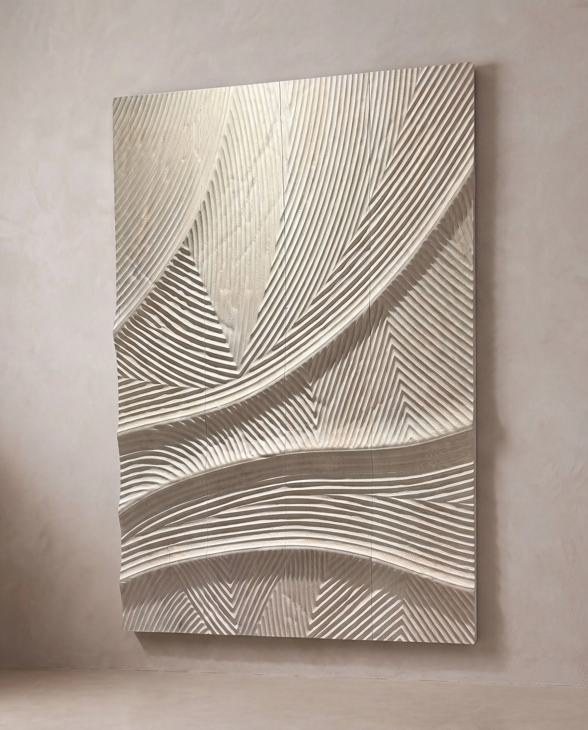 A rendering of a white carved wall panel with sweeping wave relief, hung on a limewash wall.