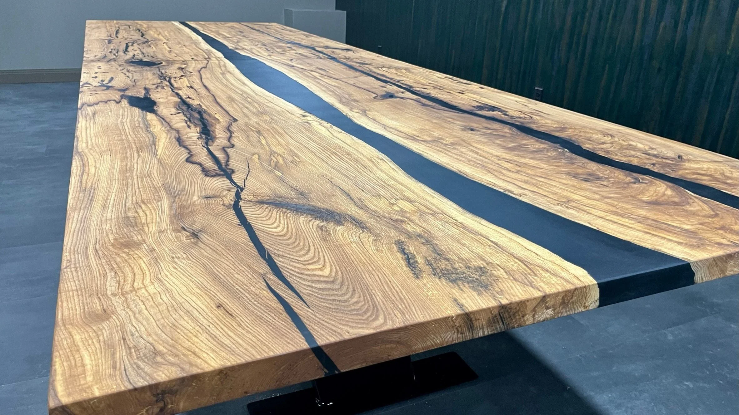 Close view of the figured grain and the dark channel at the corner of the conference table.