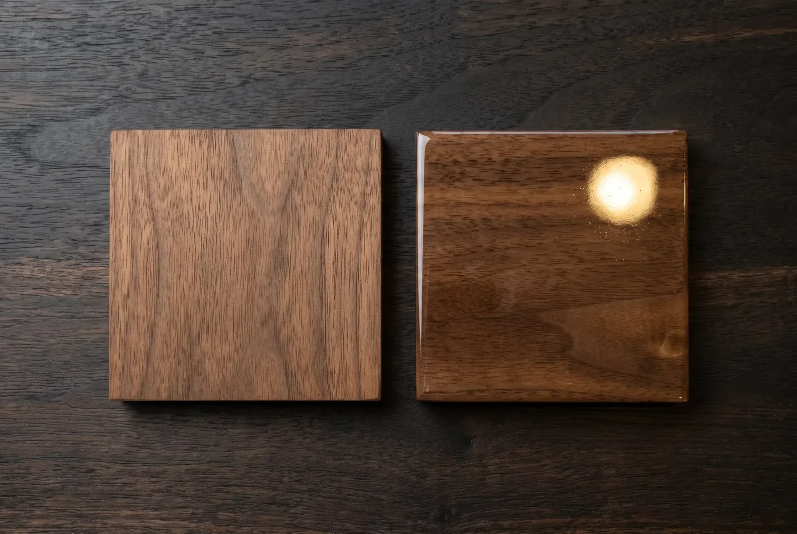 Two identical walnut swatches side by side, one in a dead-matte oil finish and one in a mirror-gloss varnish catching a single highlight.