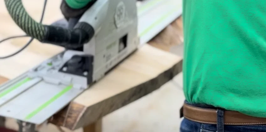 Cutting a hardwood slab with a Festool track saw for a custom wood and epoxy dining table handcrafted in Geneva, Illinois.