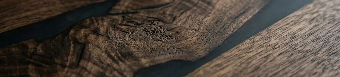 Close-up of walnut wood grain on an epoxy dining table
